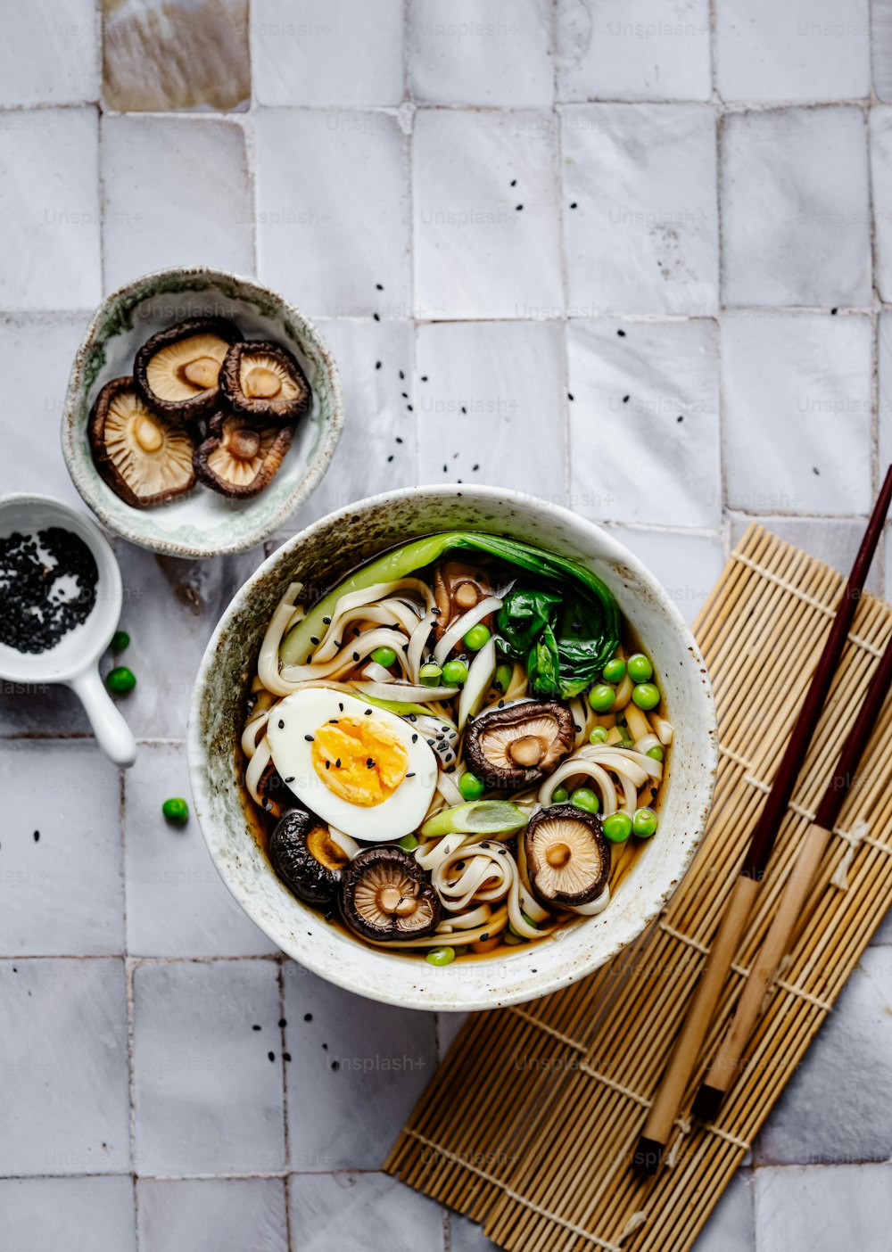 an overhead view of a bowl of noodles and mushrooms