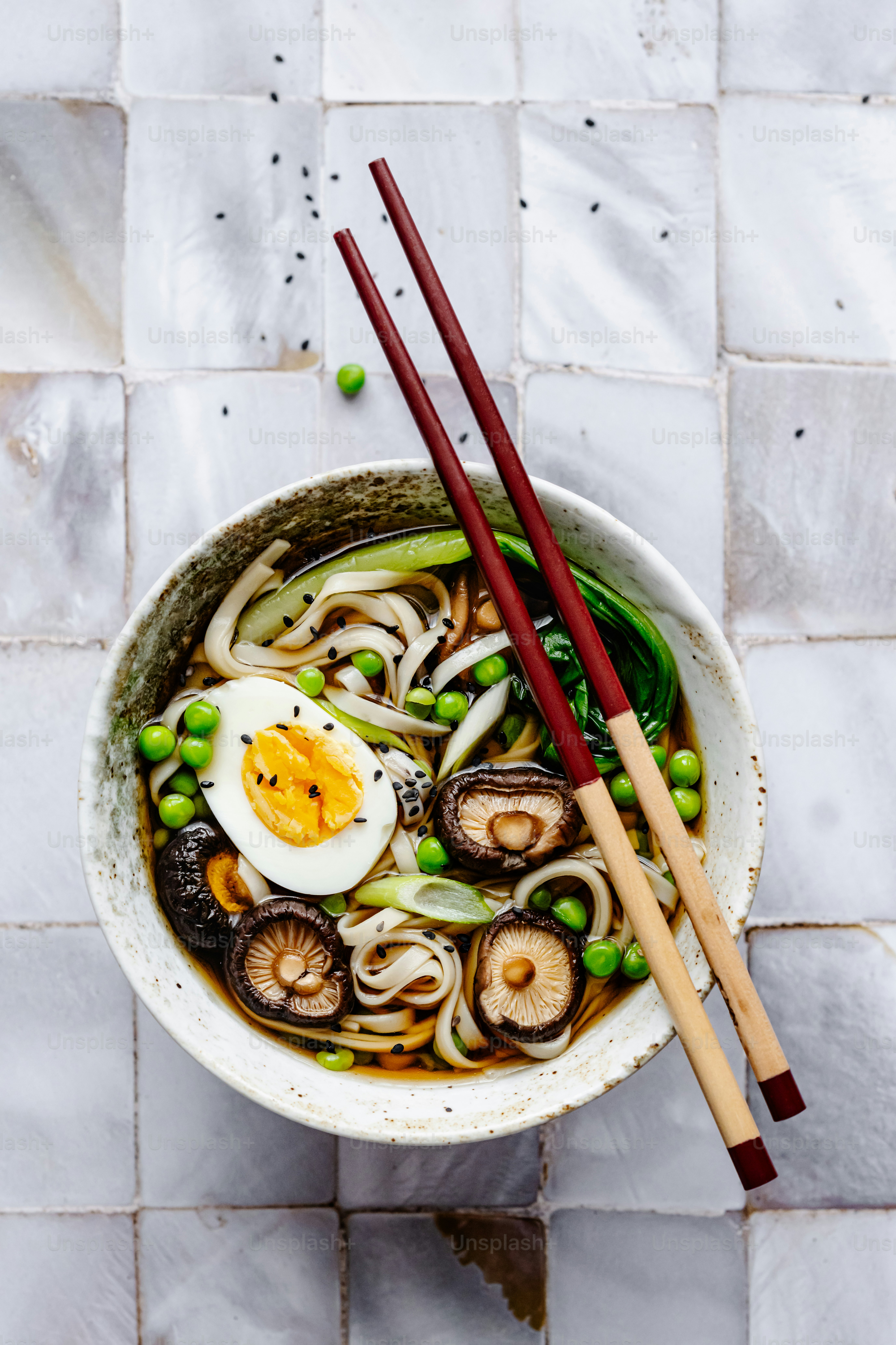 a bowl of soup with vegetables and an egg