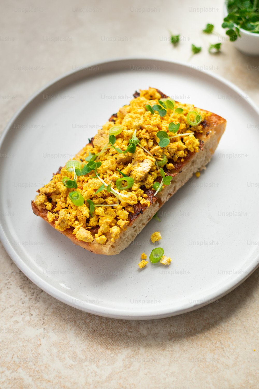 a white plate topped with a piece of food