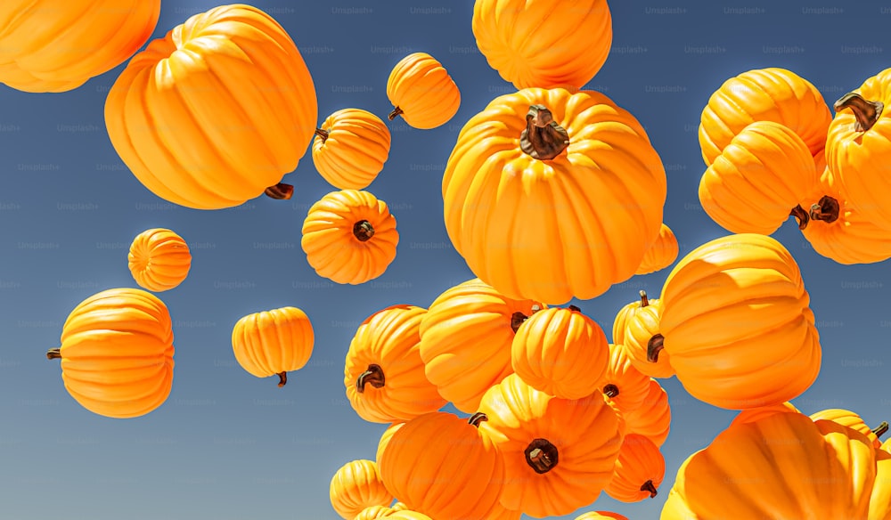 a bunch of orange pumpkins floating in the air