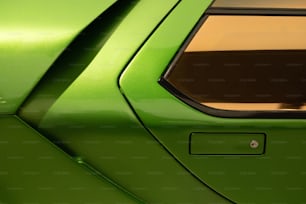 a close up of the rear end of a green sports car