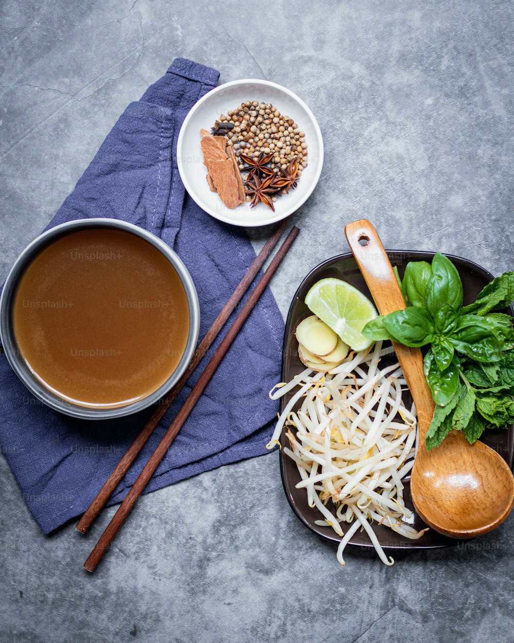 a plate of food with chopsticks and a cup of tea