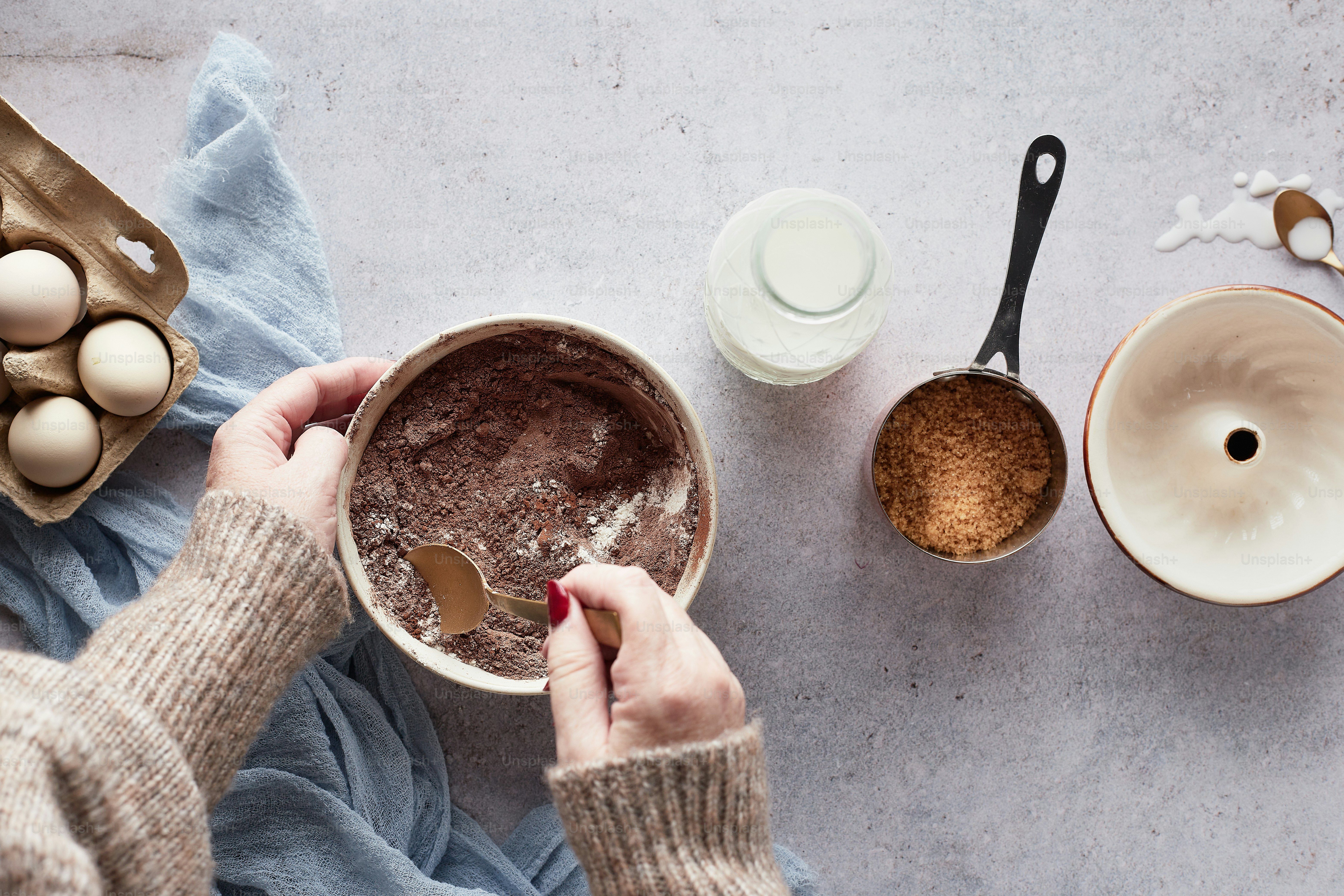 a person holding a bowl of food next to bowls and spoons