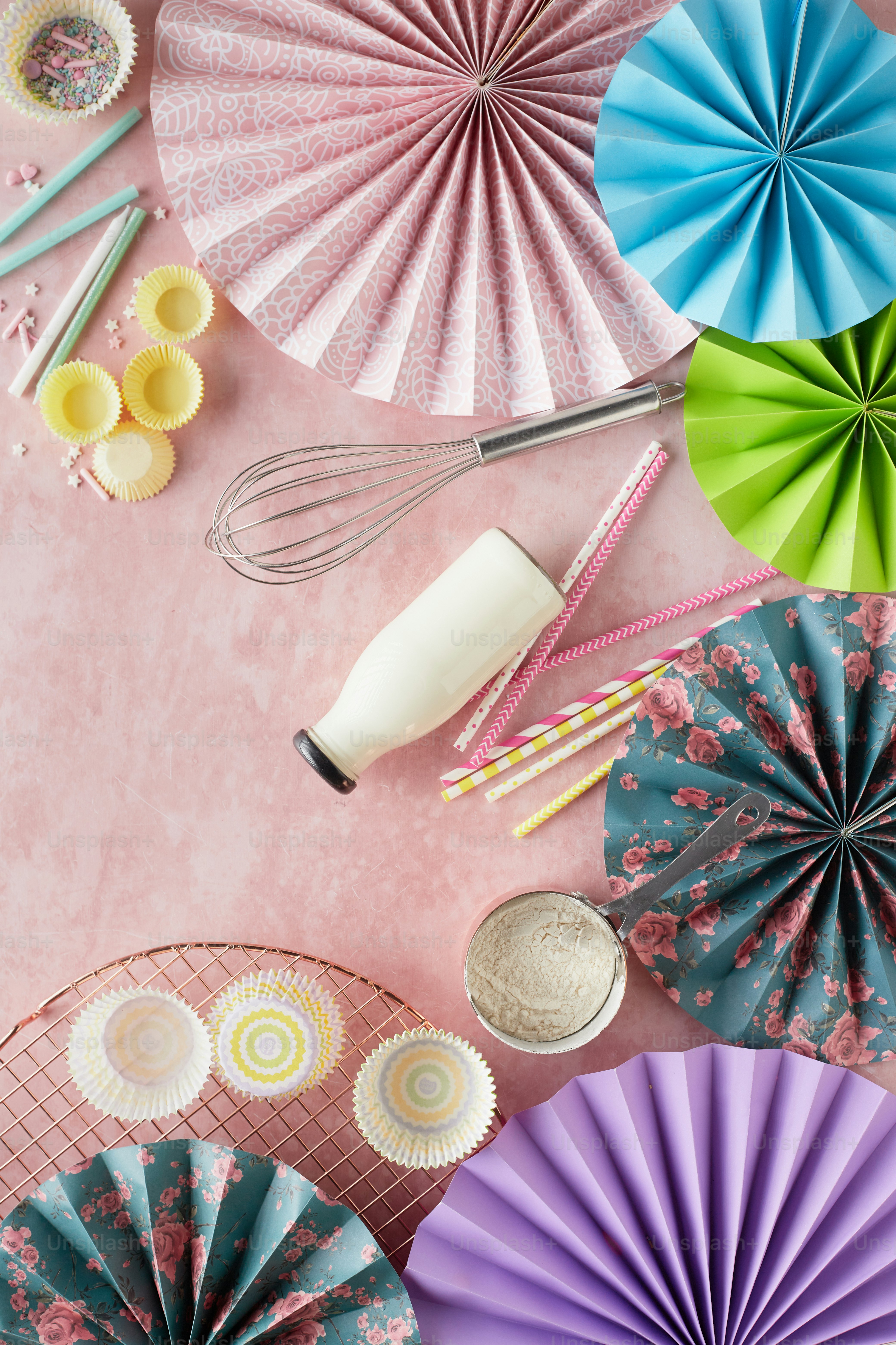 a table topped with lots of colorful paper umbrellas