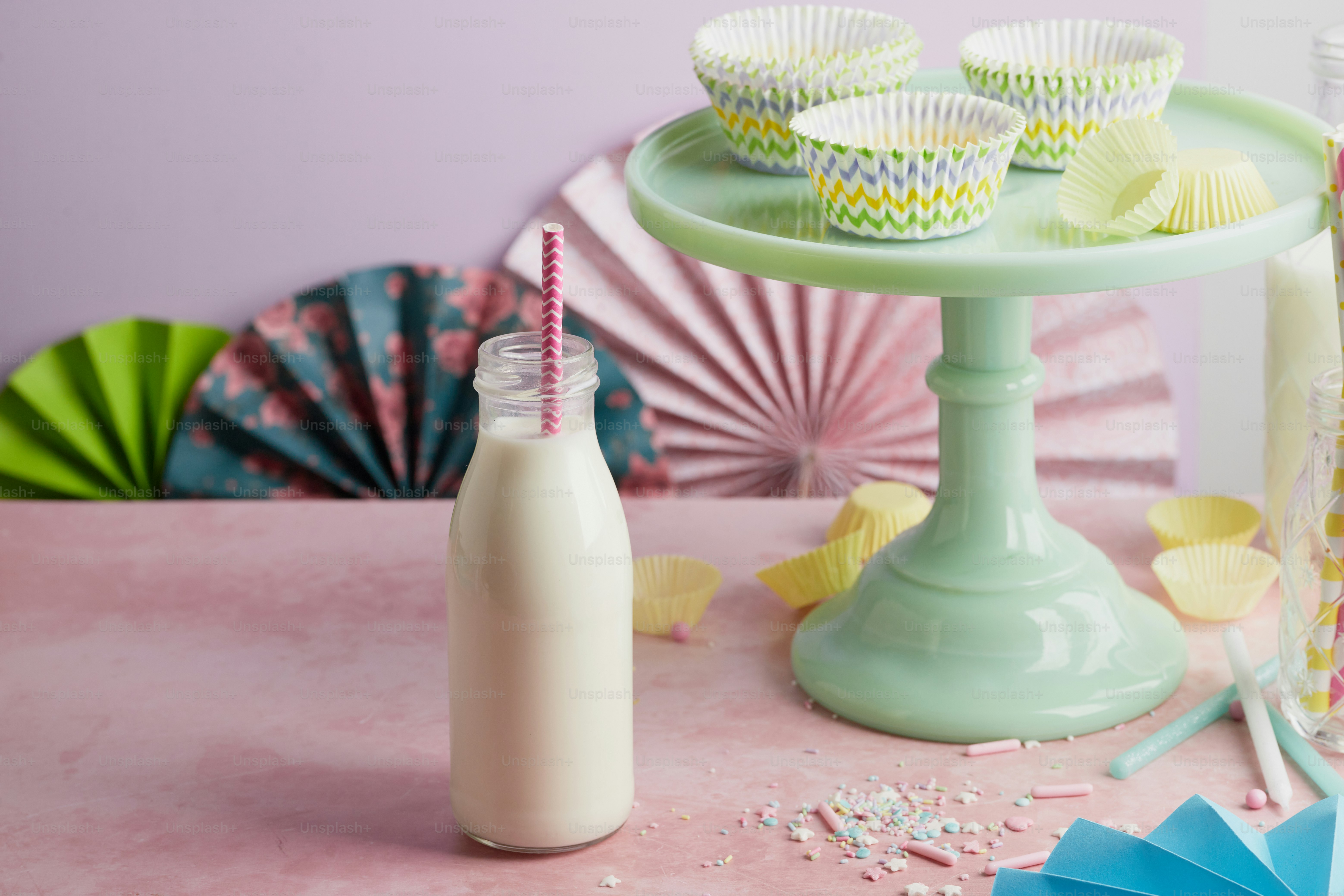 a bottle of milk and some cupcakes on a table