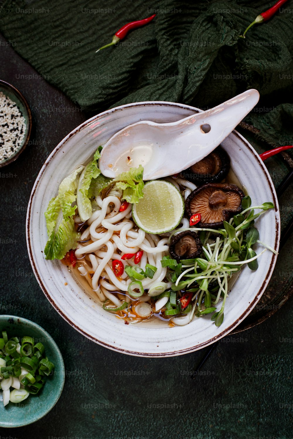 a bowl of noodle soup with mushrooms and greens