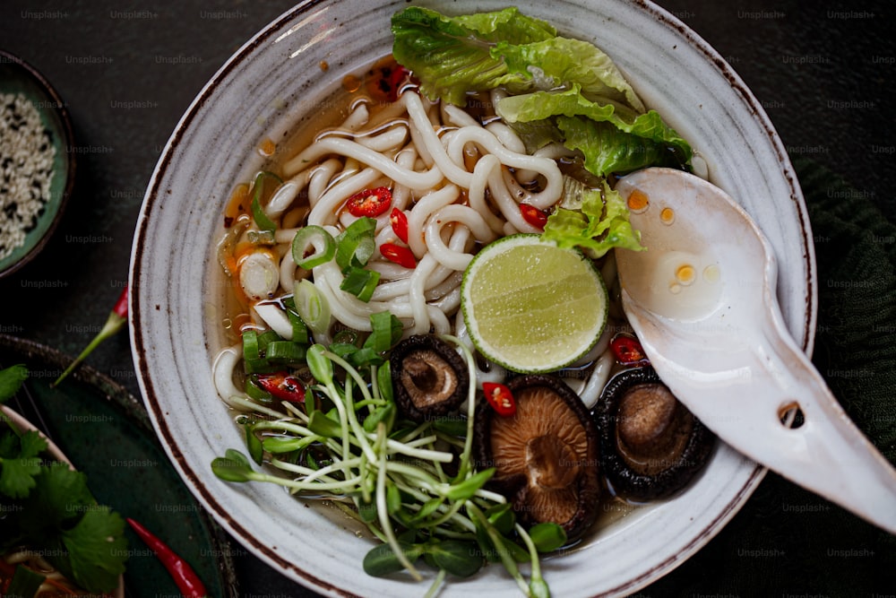 a bowl of noodle soup with a spoon in it