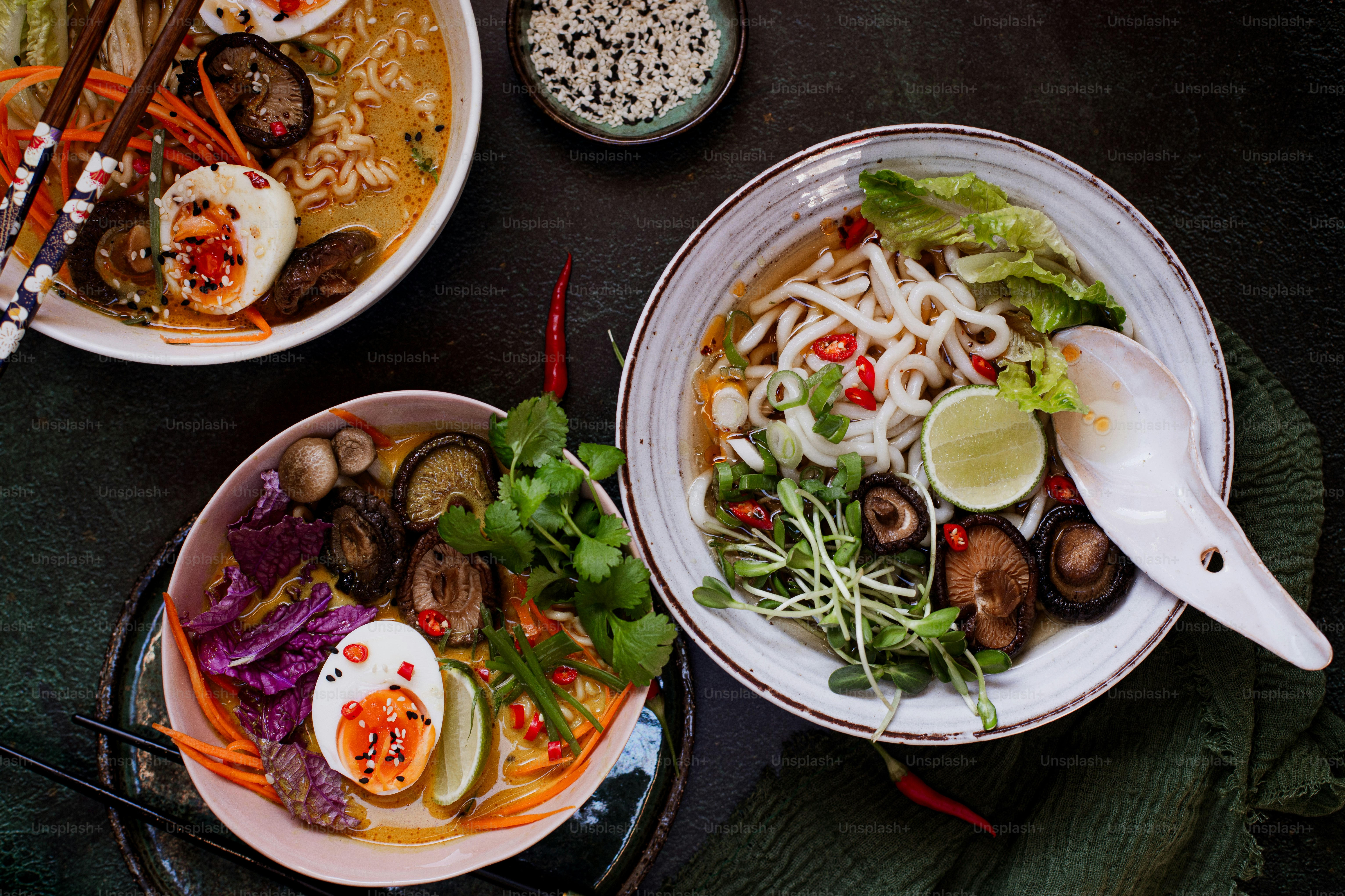 a table topped with plates of food and bowls of soup