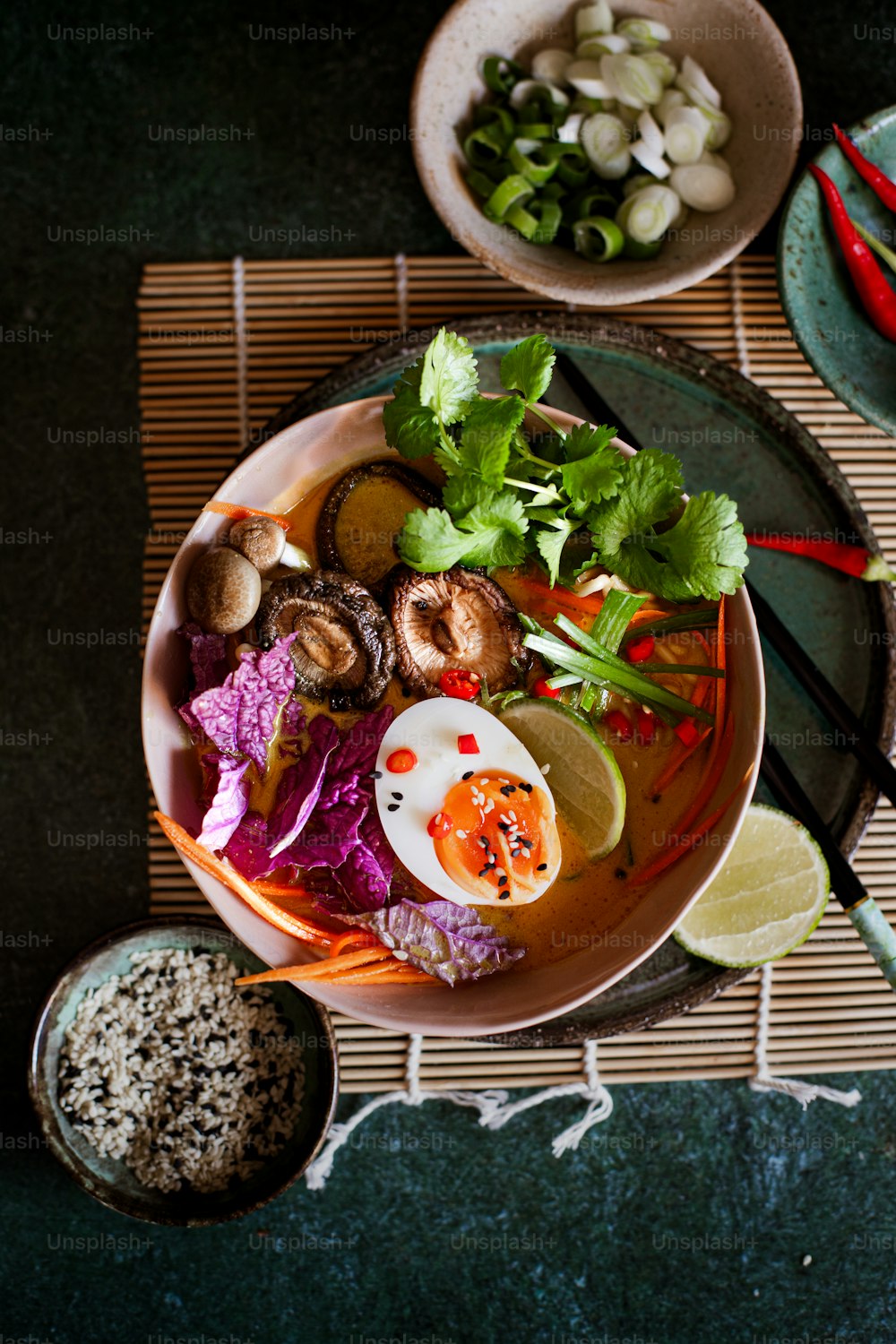 a bowl of food on a table with chopsticks