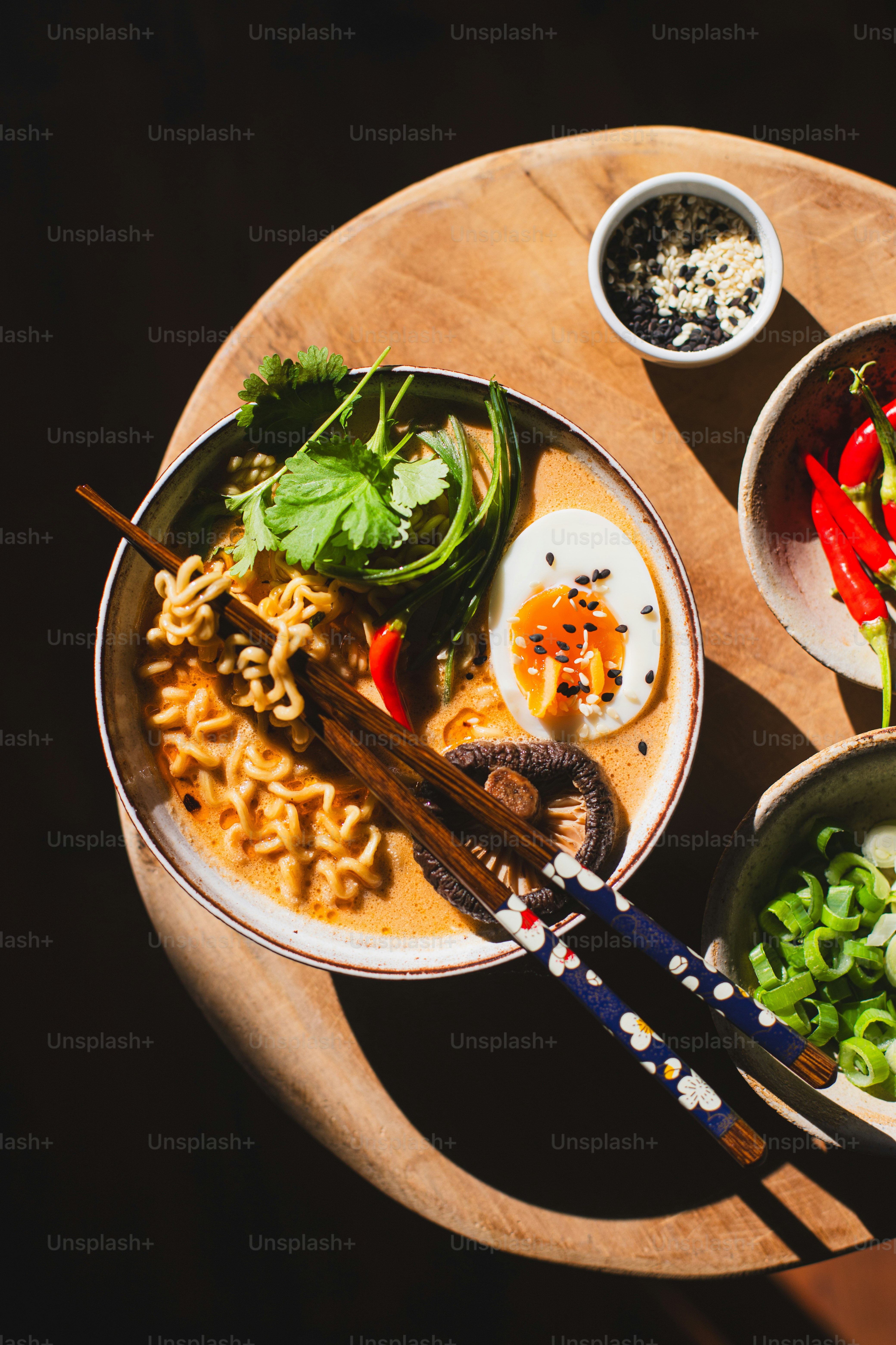 a wooden table topped with bowls of food