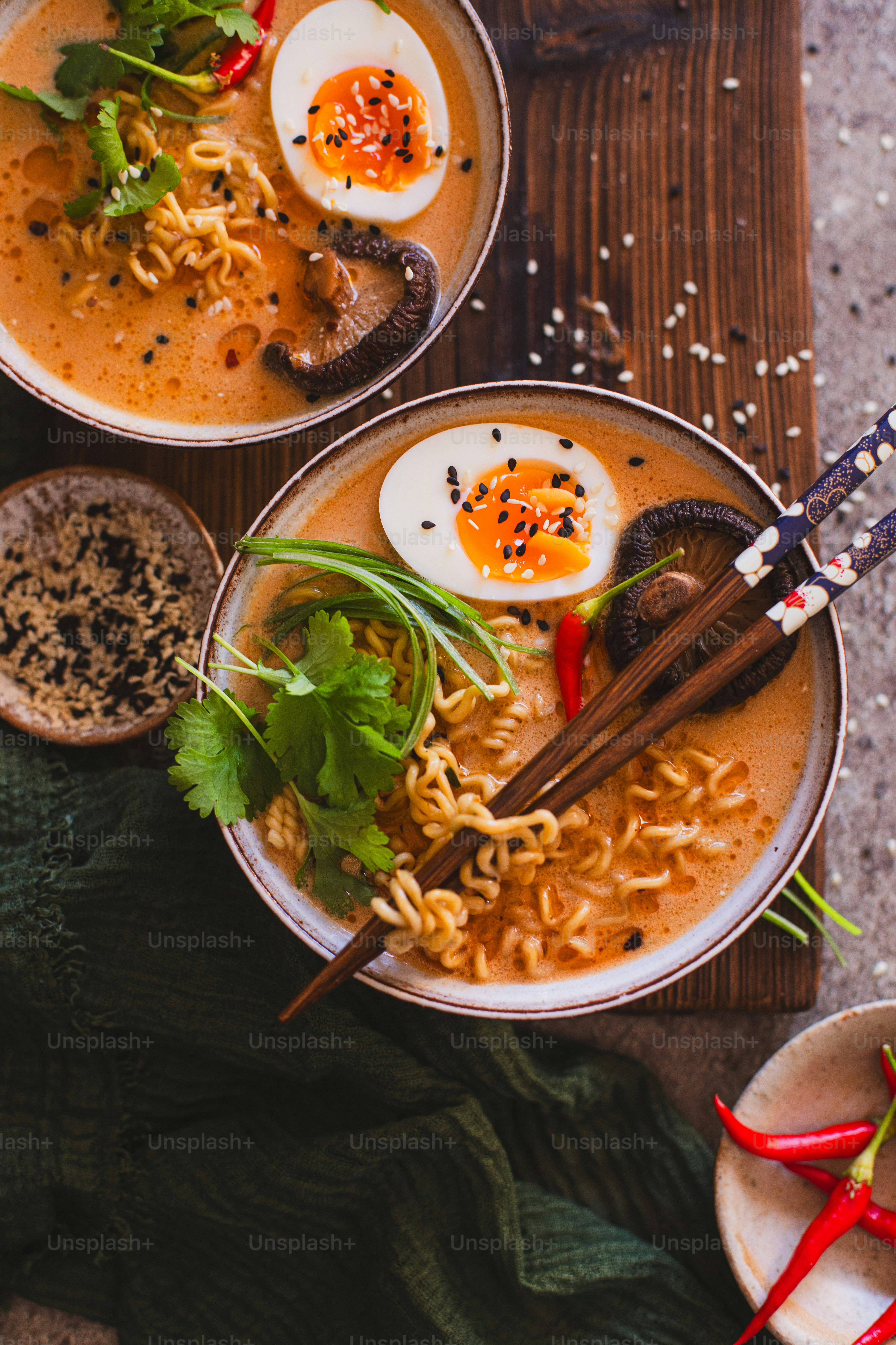 two bowls of ramen with hard boiled eggs on top