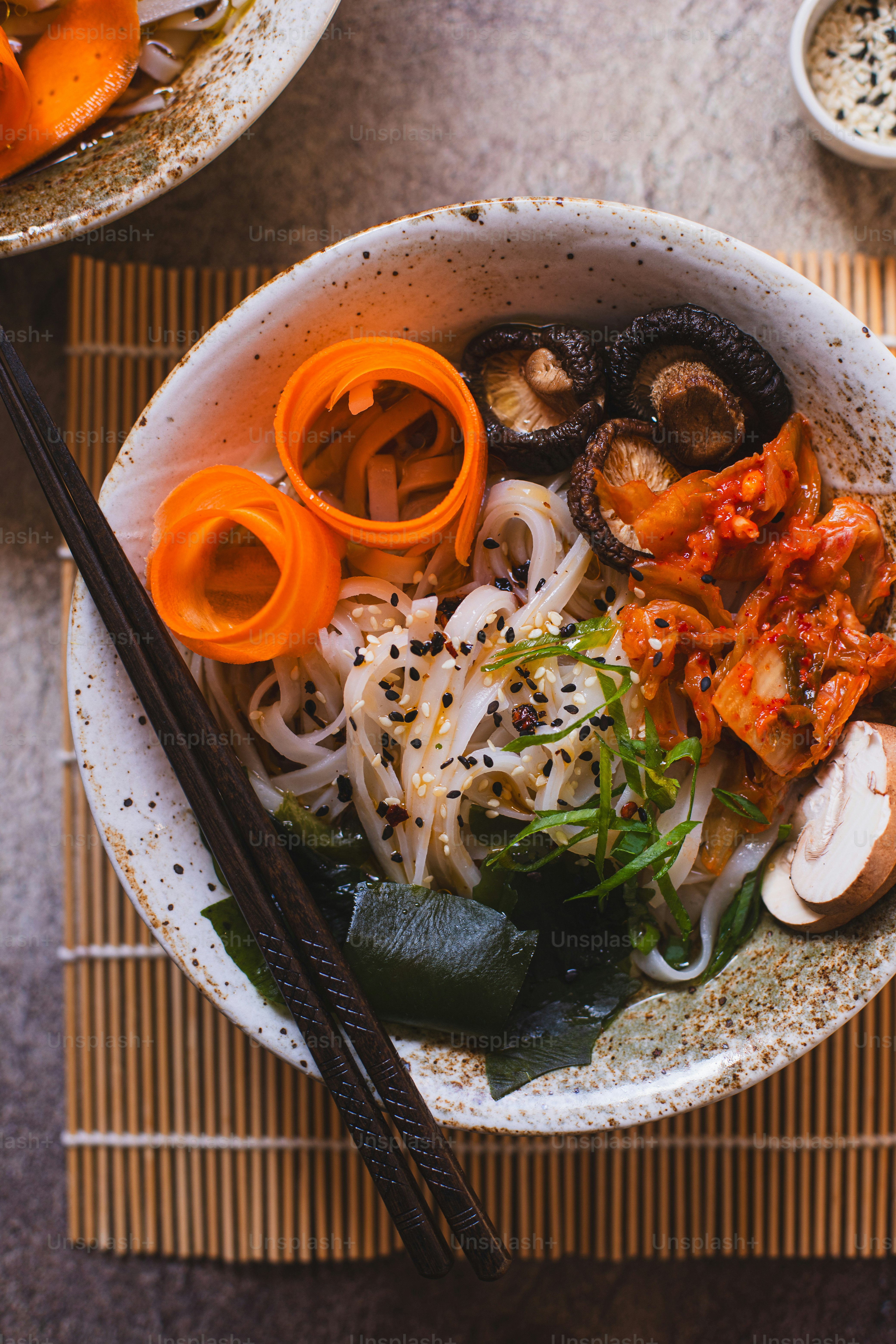 a bowl of food with chopsticks on the side