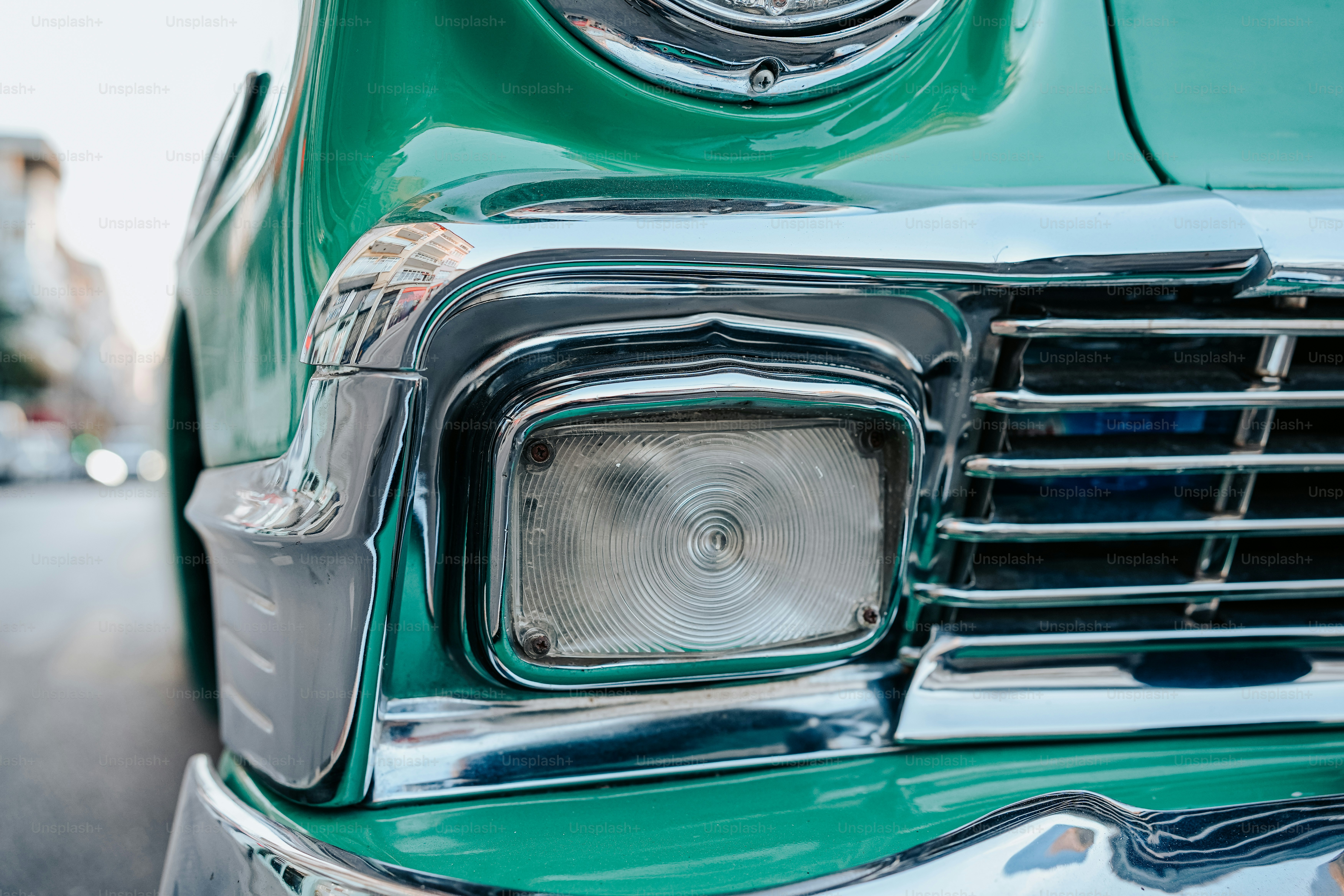 a close up of the front end of a green car