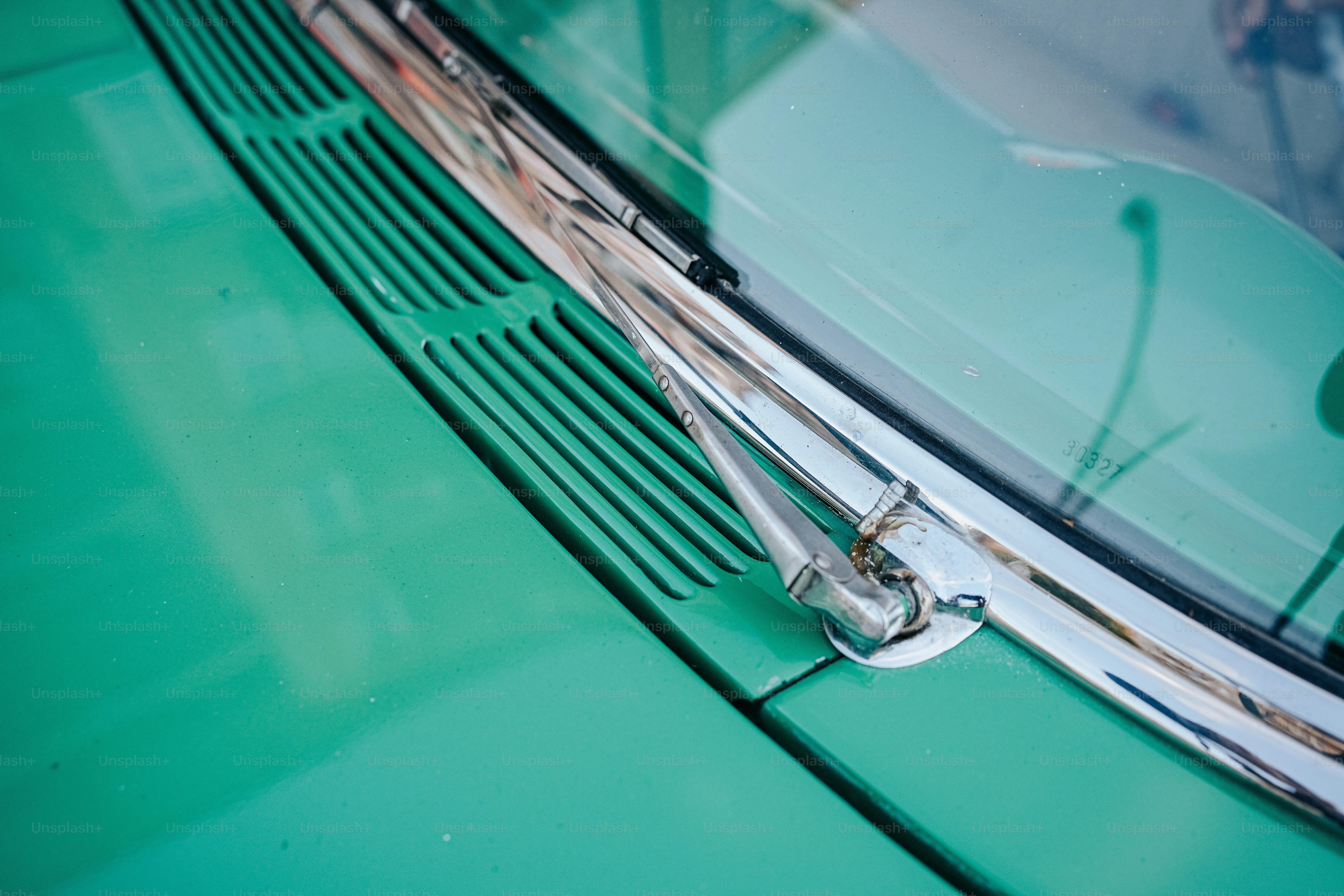 a close up of the front of a green car