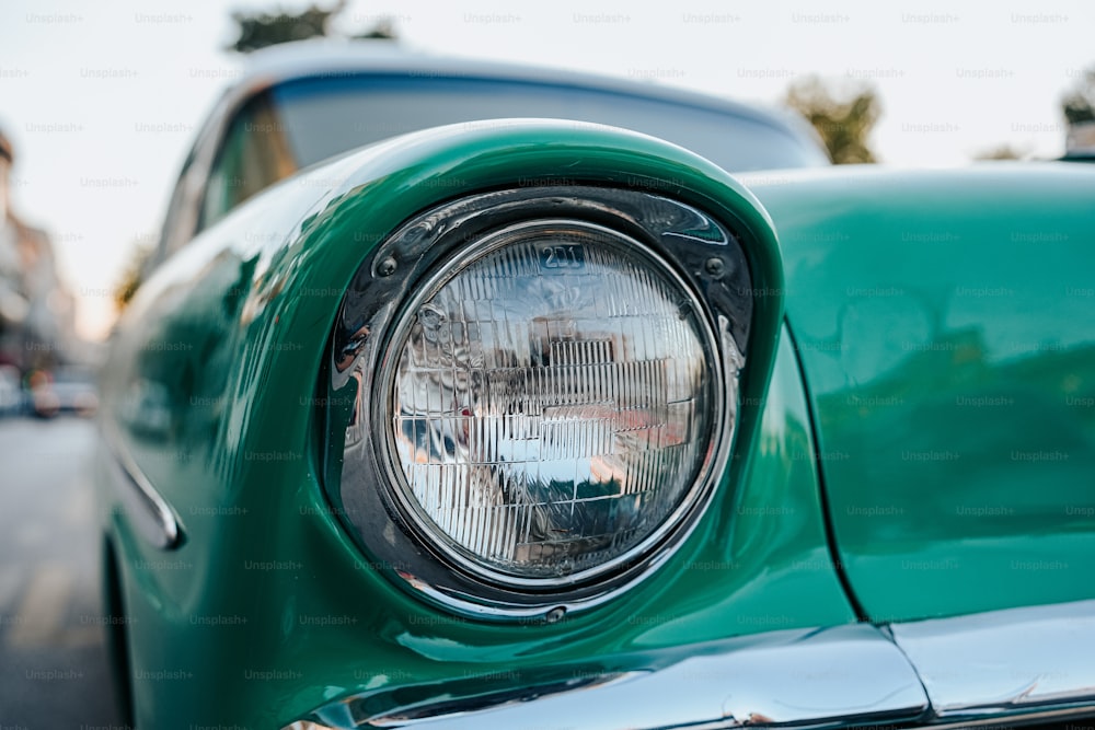 a close up of a green car headlight