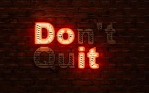 a neon sign that says don't cut on a brick wall