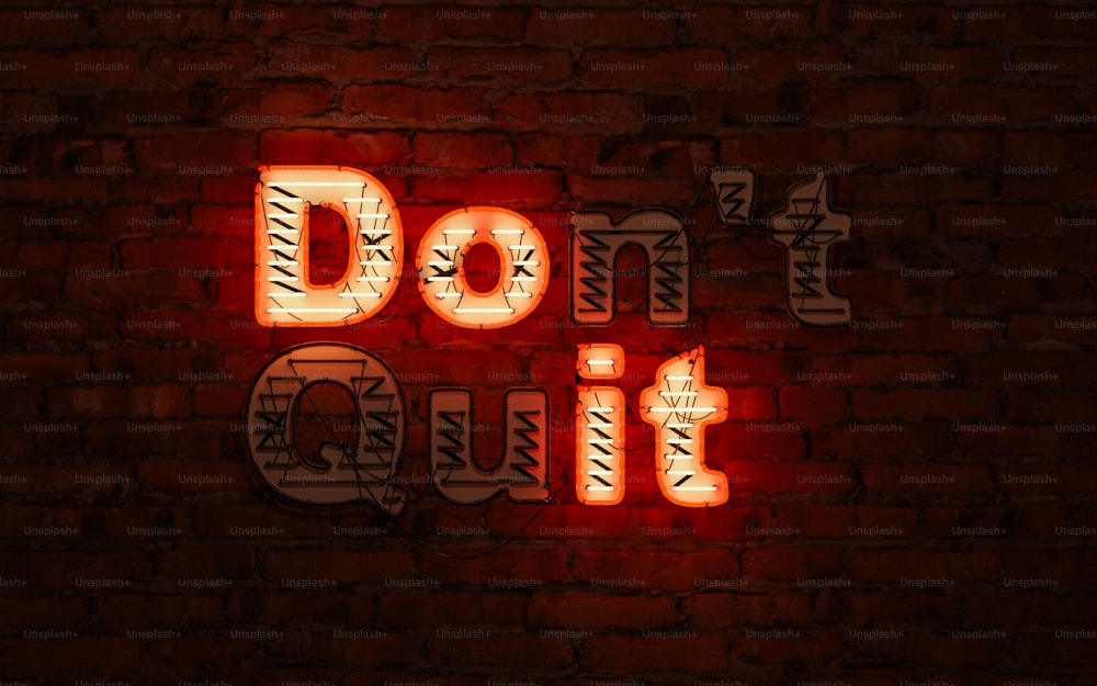 a neon sign that says don't cut on a brick wall