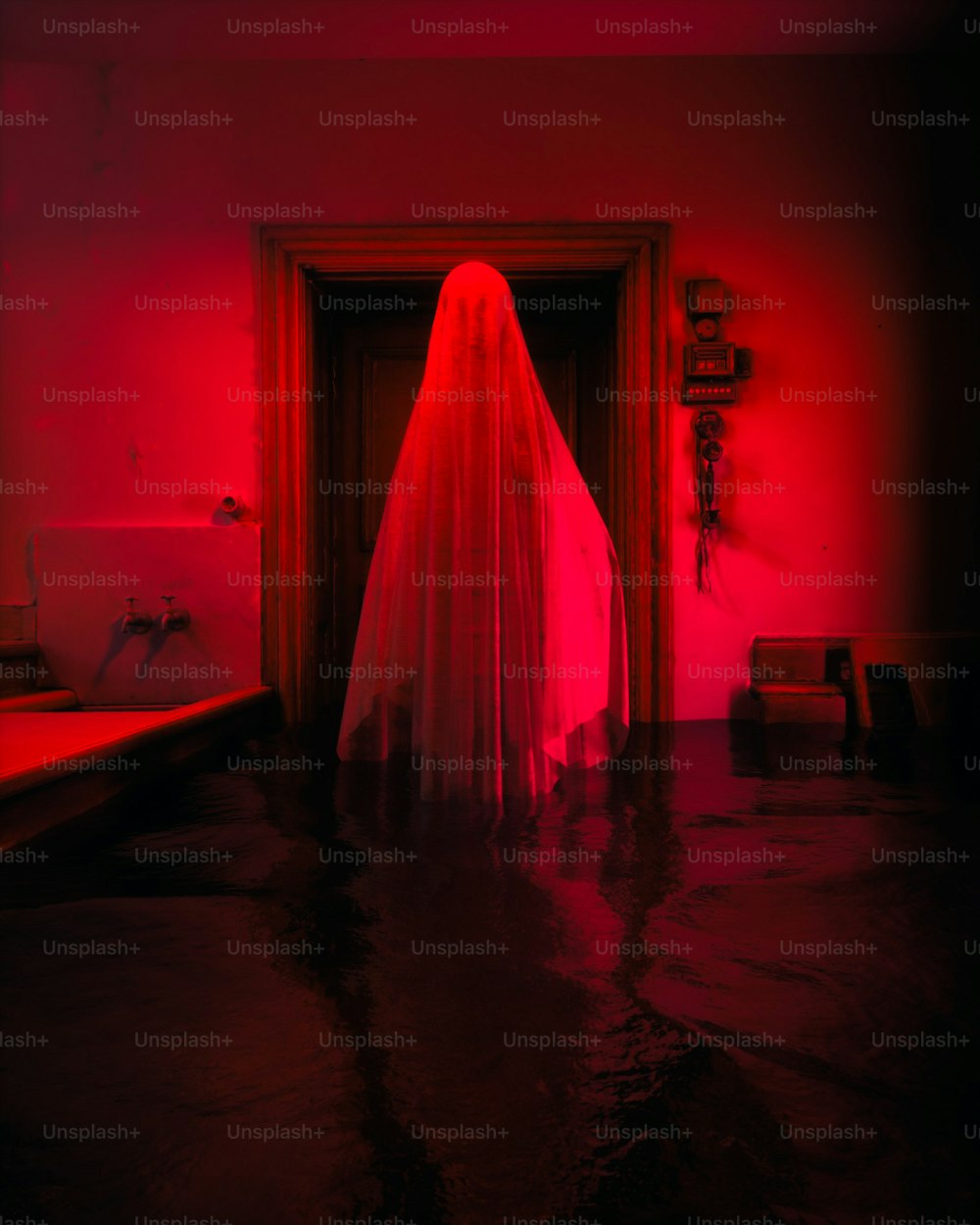 a ghost in a red room with a red light