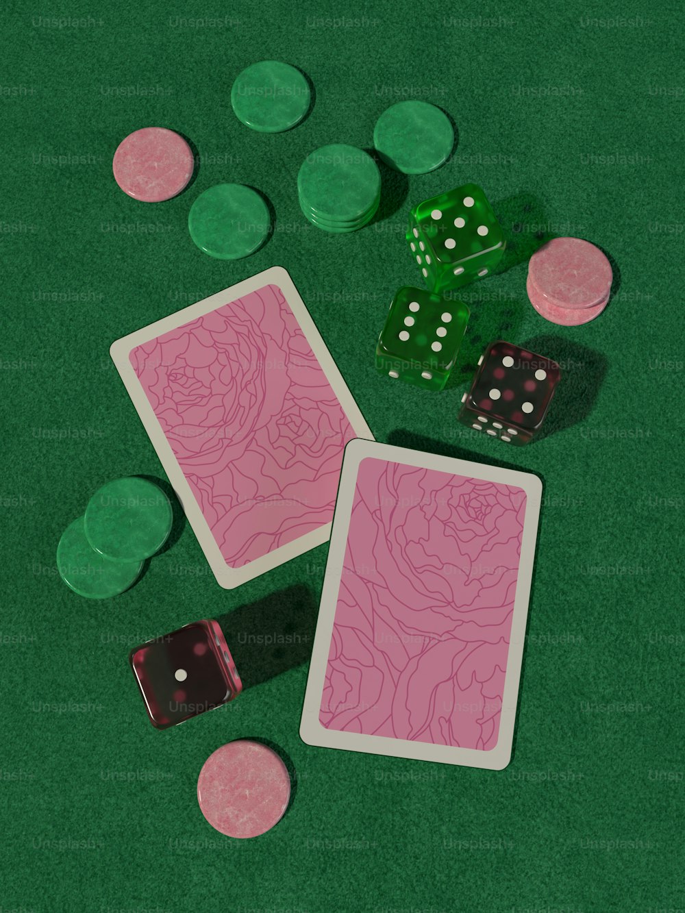 two playing cards and two dice on a green table