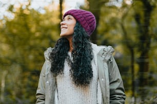 Una mujer con cabello largo y negro con un sombrero púrpura