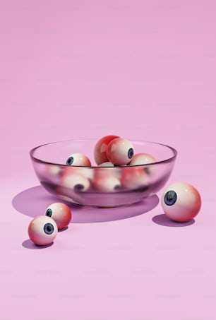a glass bowl filled with red and white balls