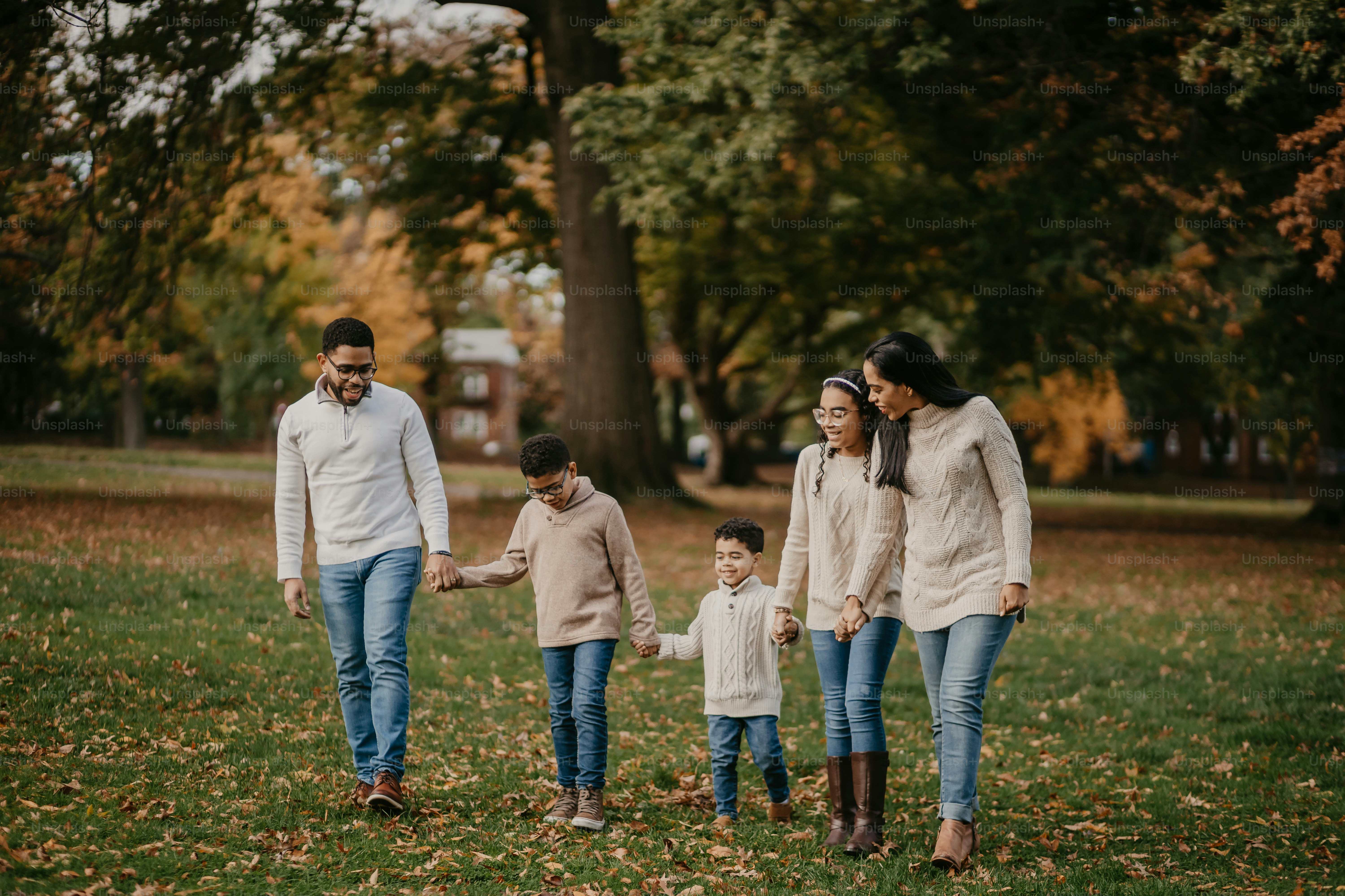 a family walking through a park holding hands
