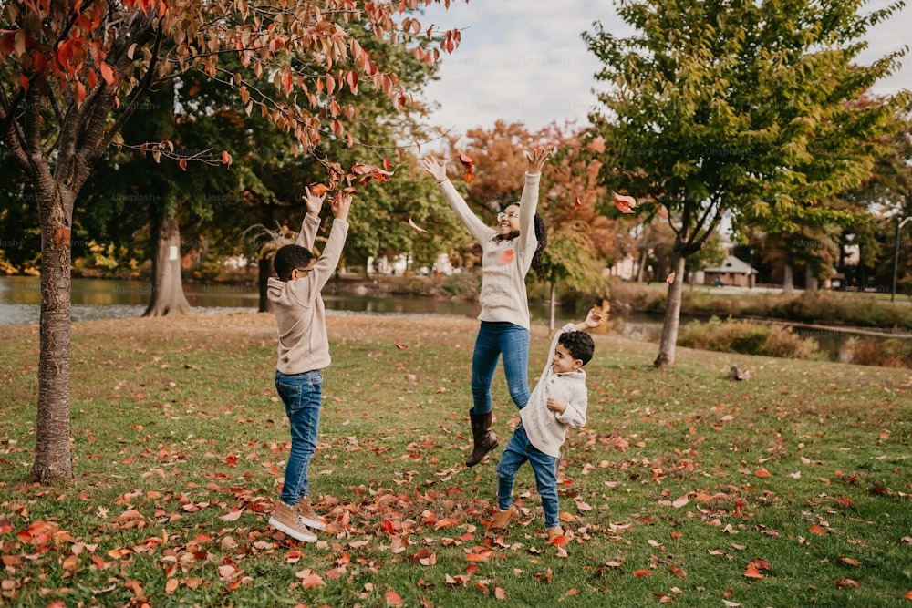 a group of people throwing leaves in the air