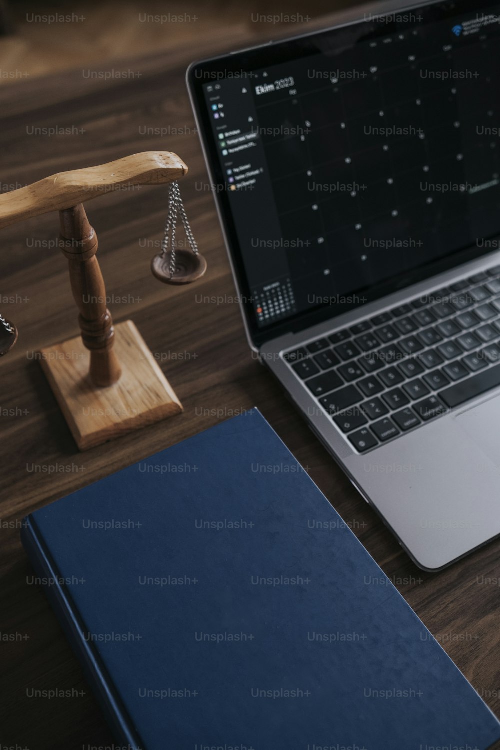 a laptop computer sitting on top of a wooden desk