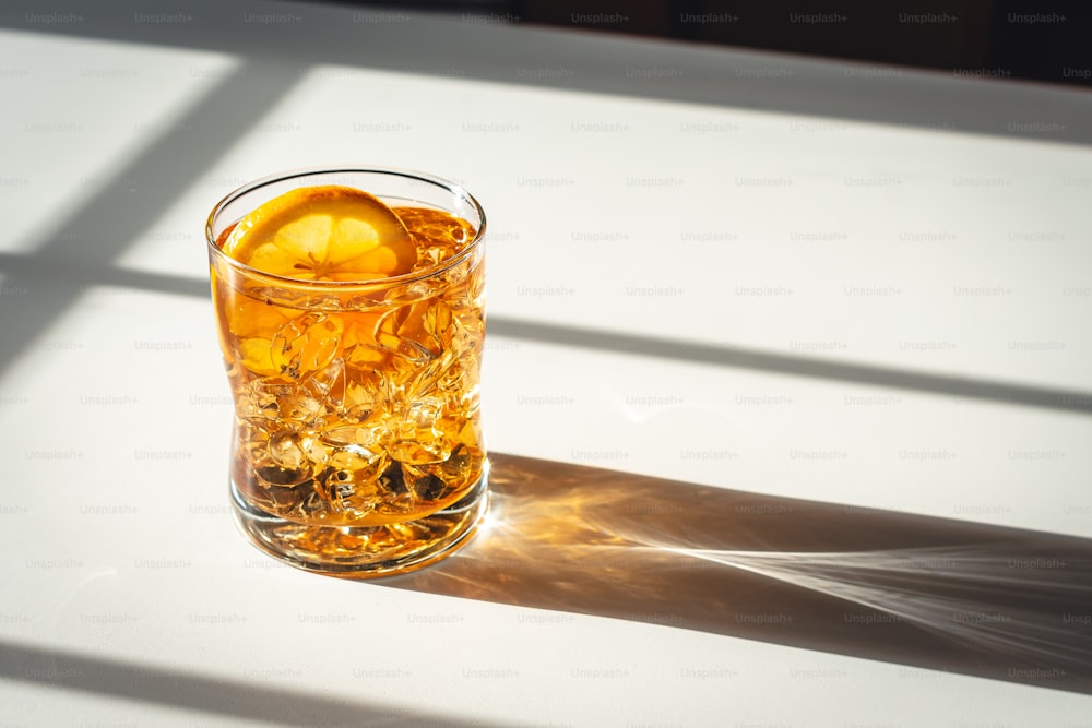 a glass of ice tea with an orange slice