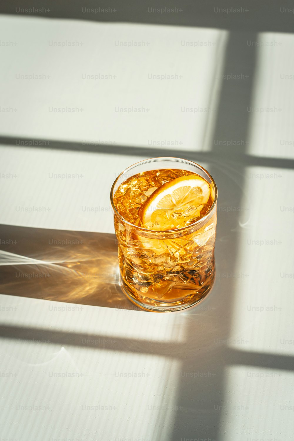 a glass of iced tea with a slice of lemon