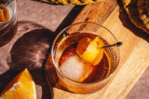 a glass filled with ice and orange slices