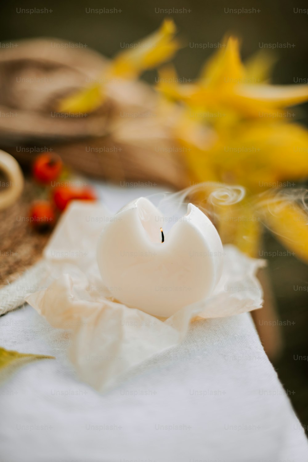 a white candle sitting on top of a table