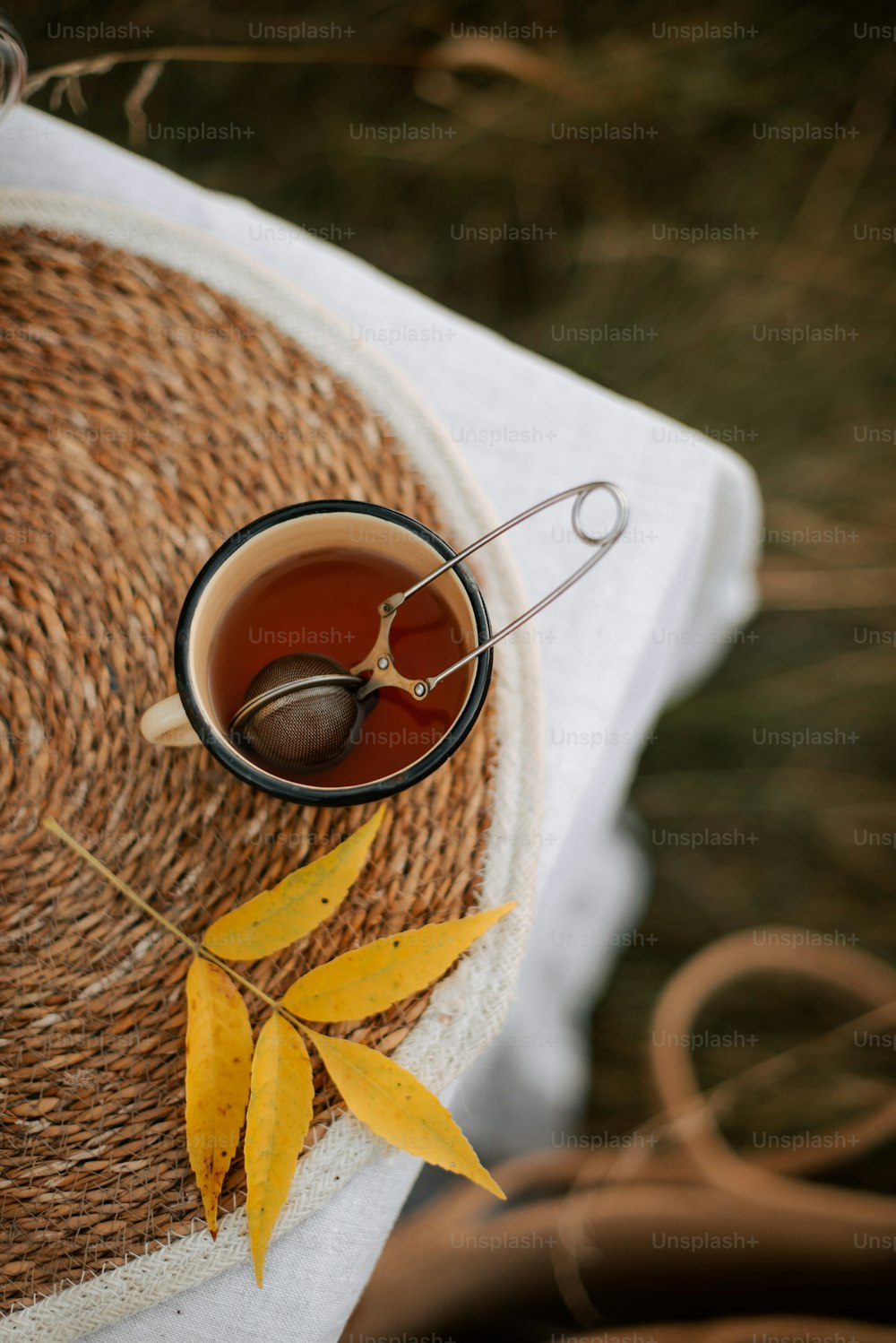 a cup of tea with a spoon on a table