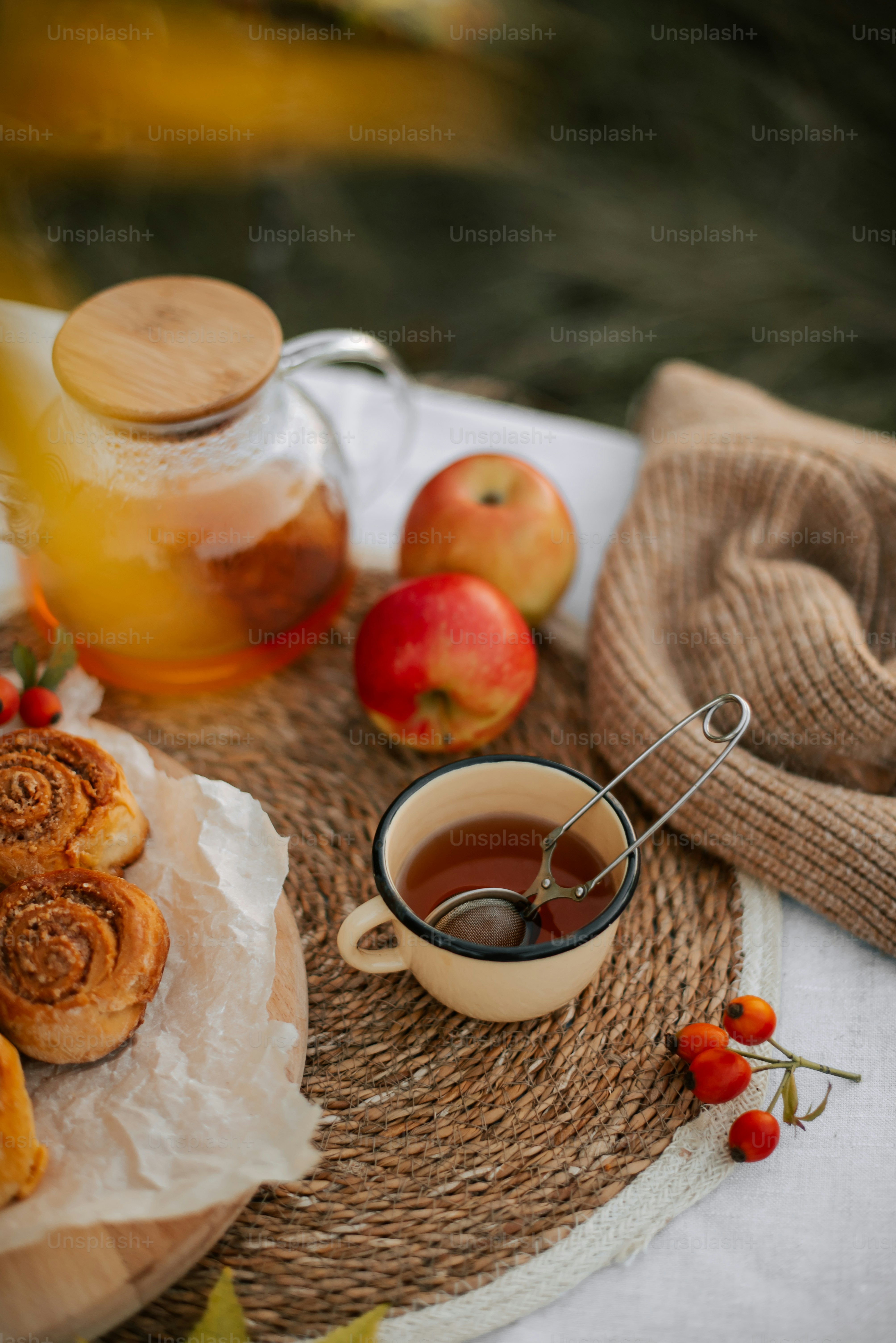 a table topped with a cup of tea and a plate of food