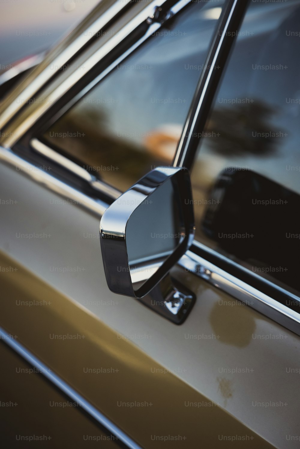 the side view mirror of a car with a blurry background