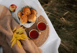 a plate of pastries and two cups of tea