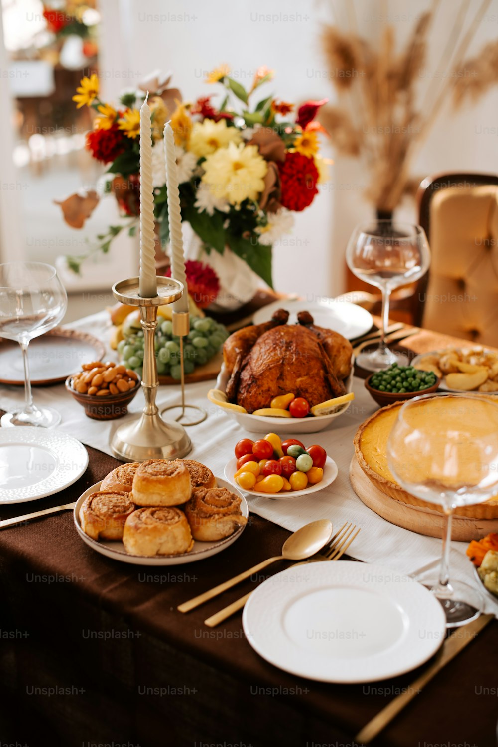 a table is set with a turkey and other food