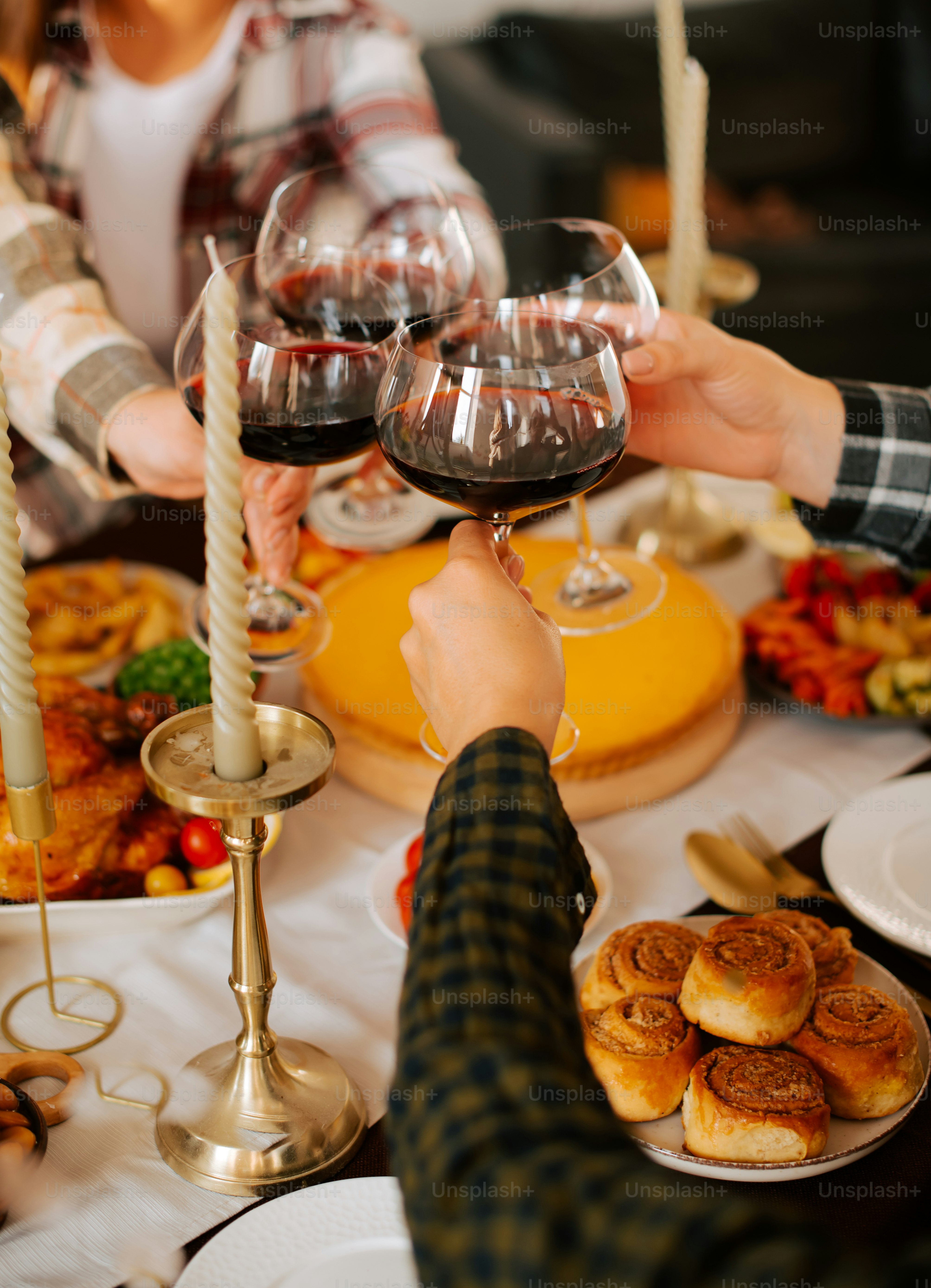 A group of people sitting around a table with food and wine glasses photo   Thanksgiving Image on Unsplash