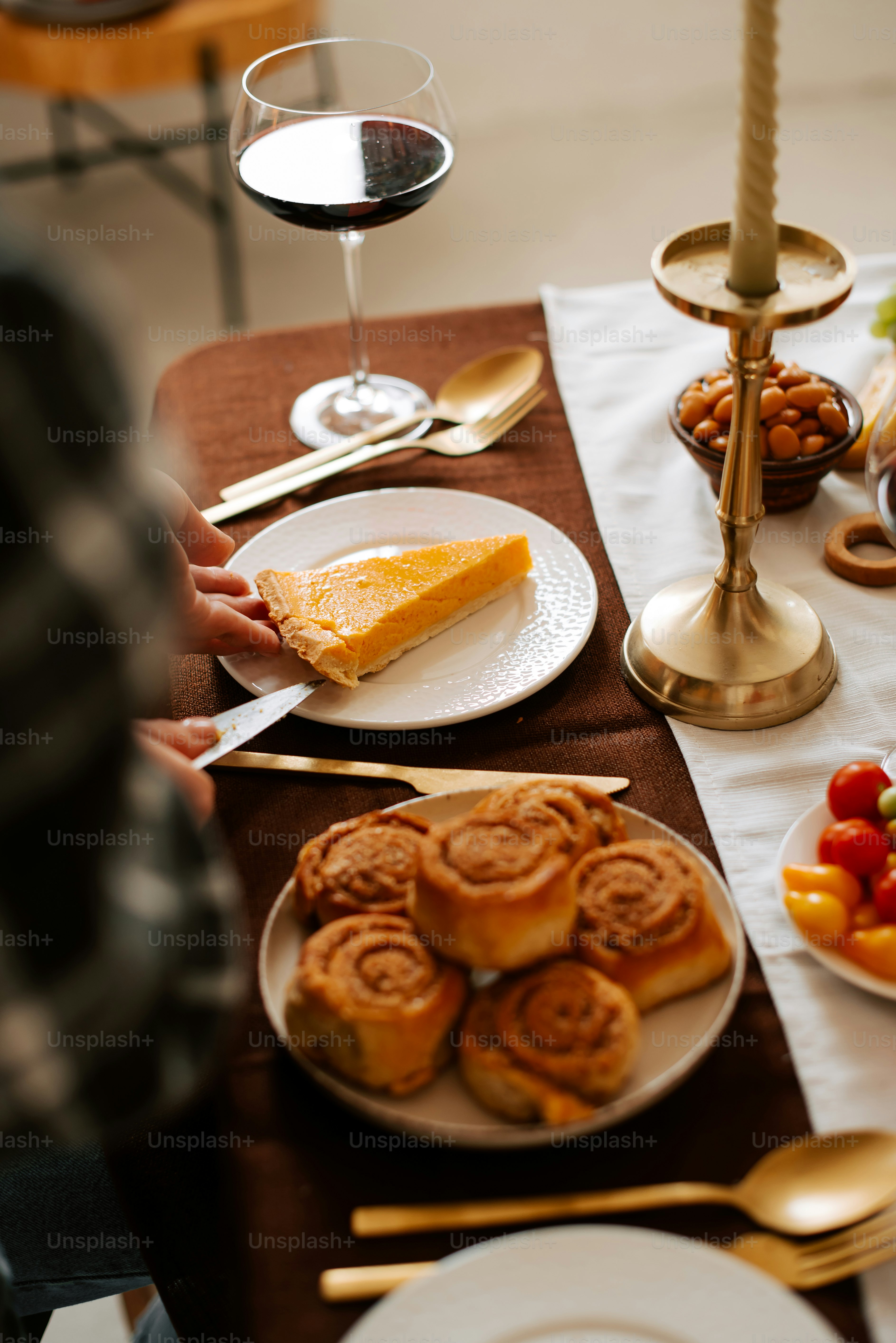 a table topped with plates of food and a glass of wine