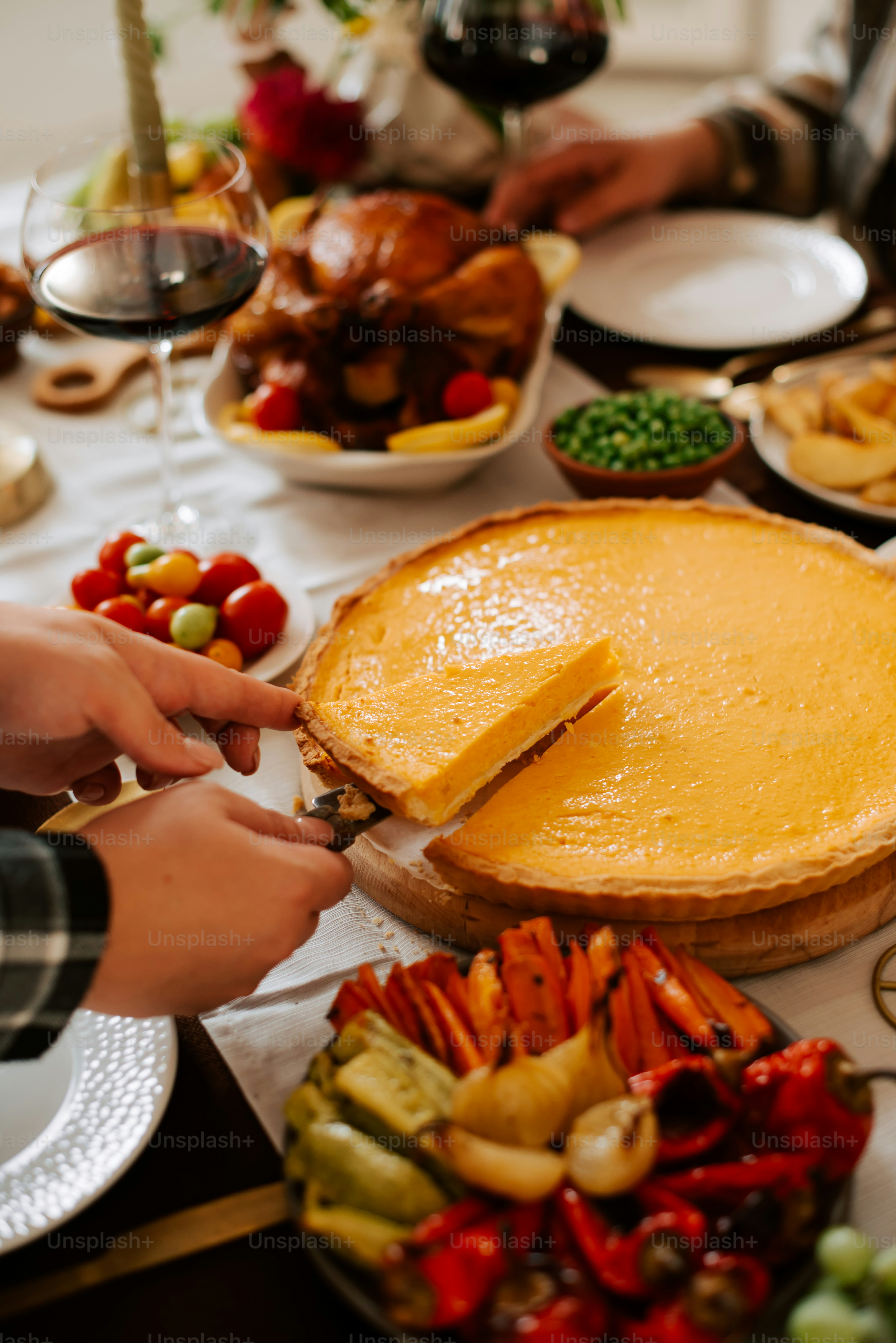 a person cutting into a pie on a table