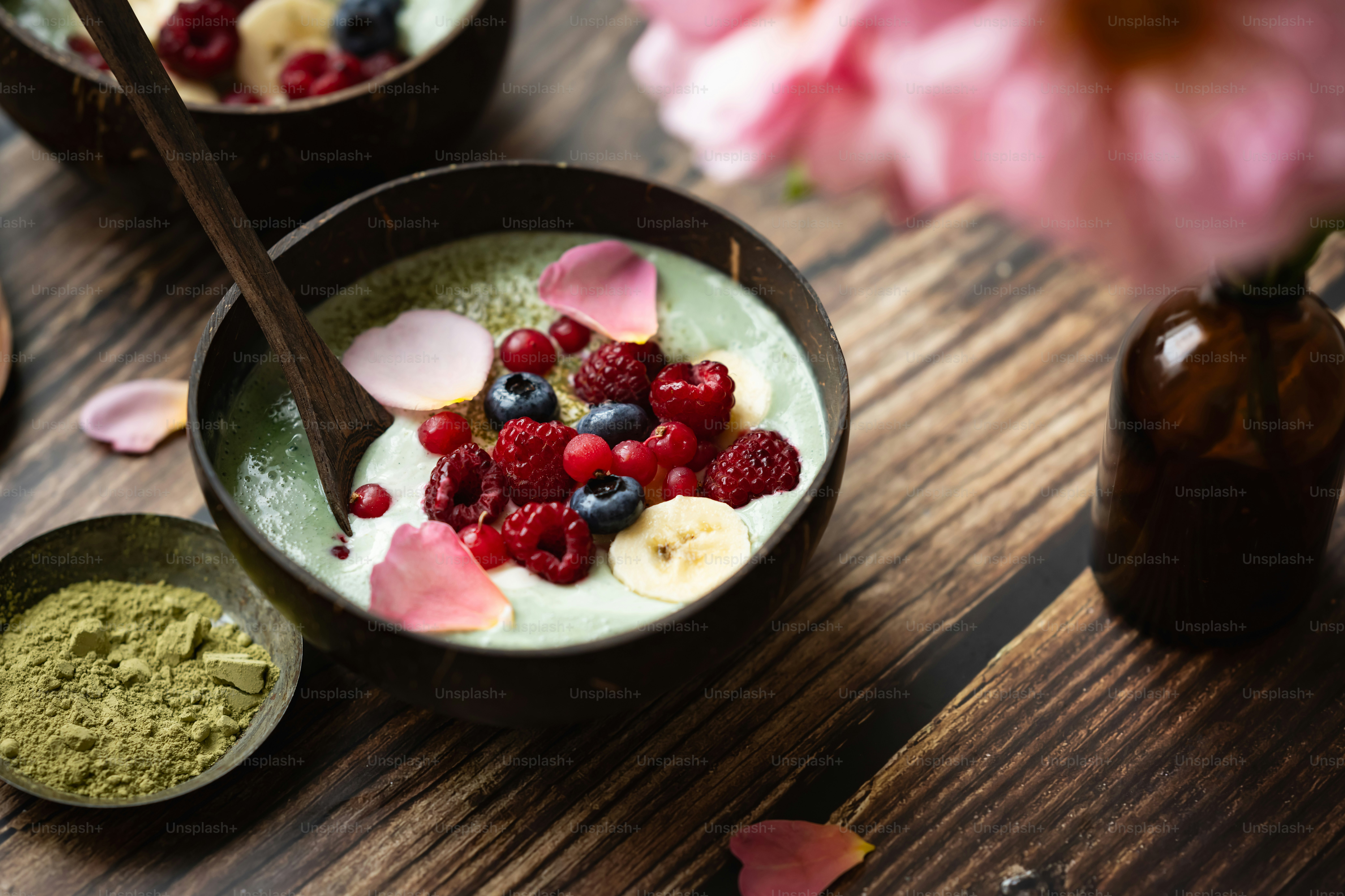 a wooden table topped with bowls of food