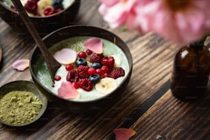 a wooden table topped with bowls of food