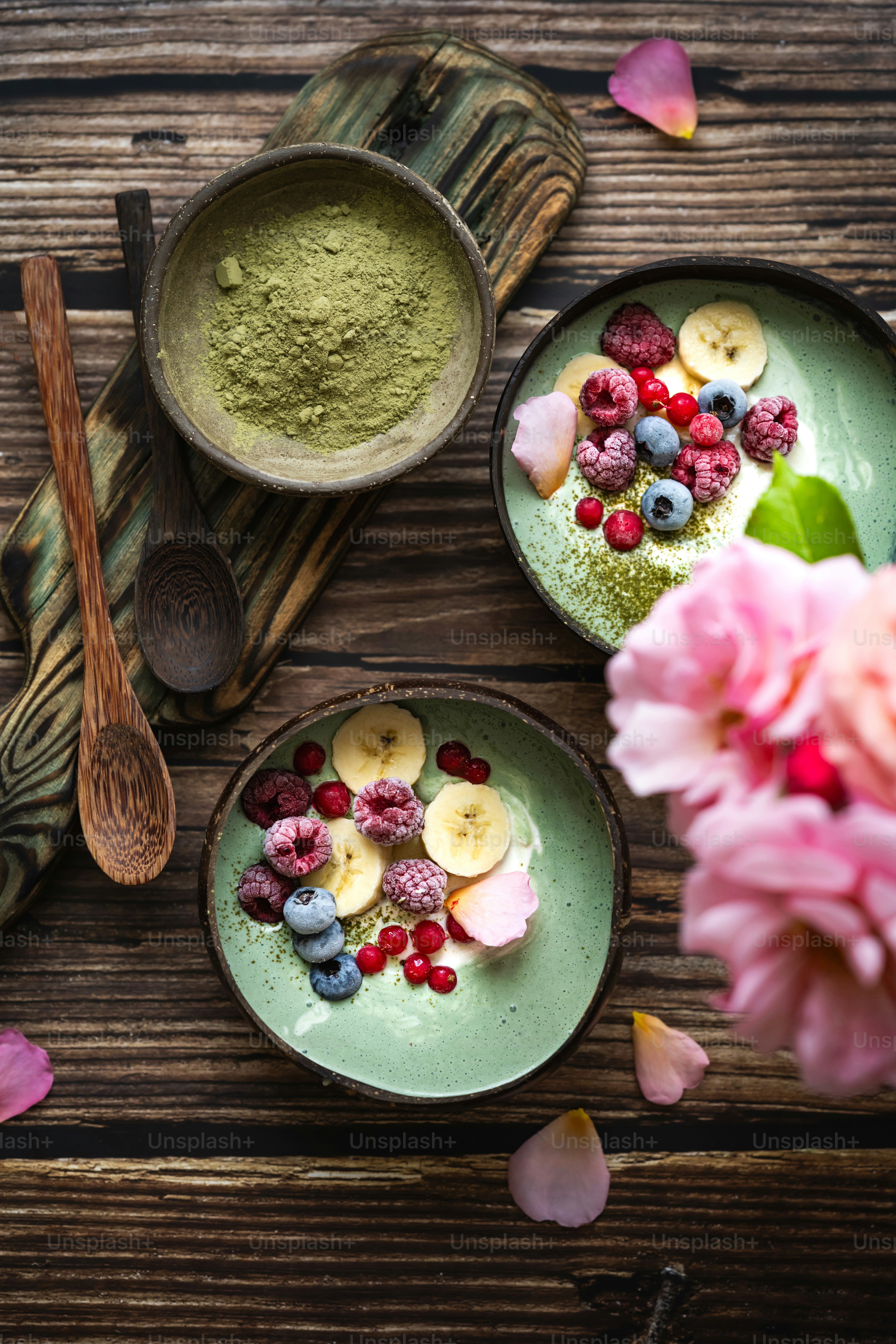 a couple of bowls filled with food on top of a wooden table