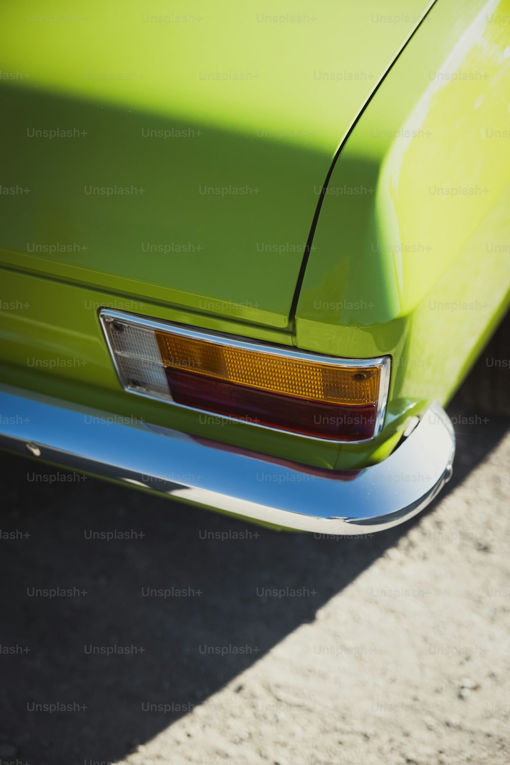 a close up of the tail light of a green car