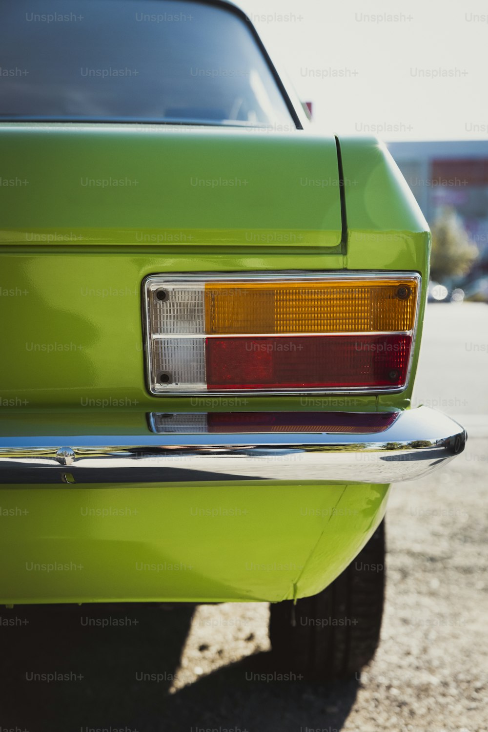 a close up of the tail light of a green car