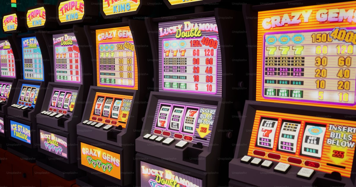 A row of slot machines sitting next to each other photo – Gambling ...