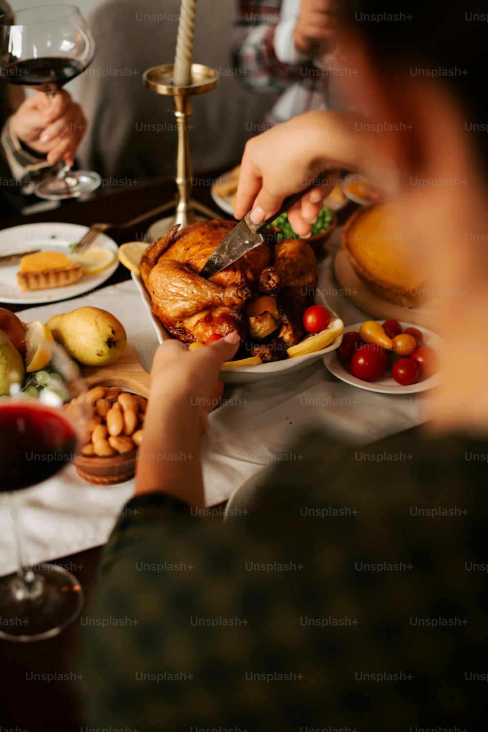 a person cutting a turkey on a table