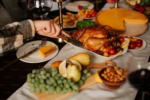 a person cutting a turkey on a table