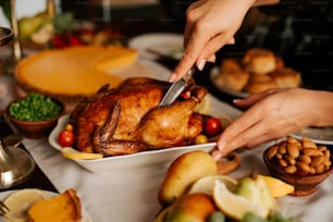 a person cutting a turkey on a table