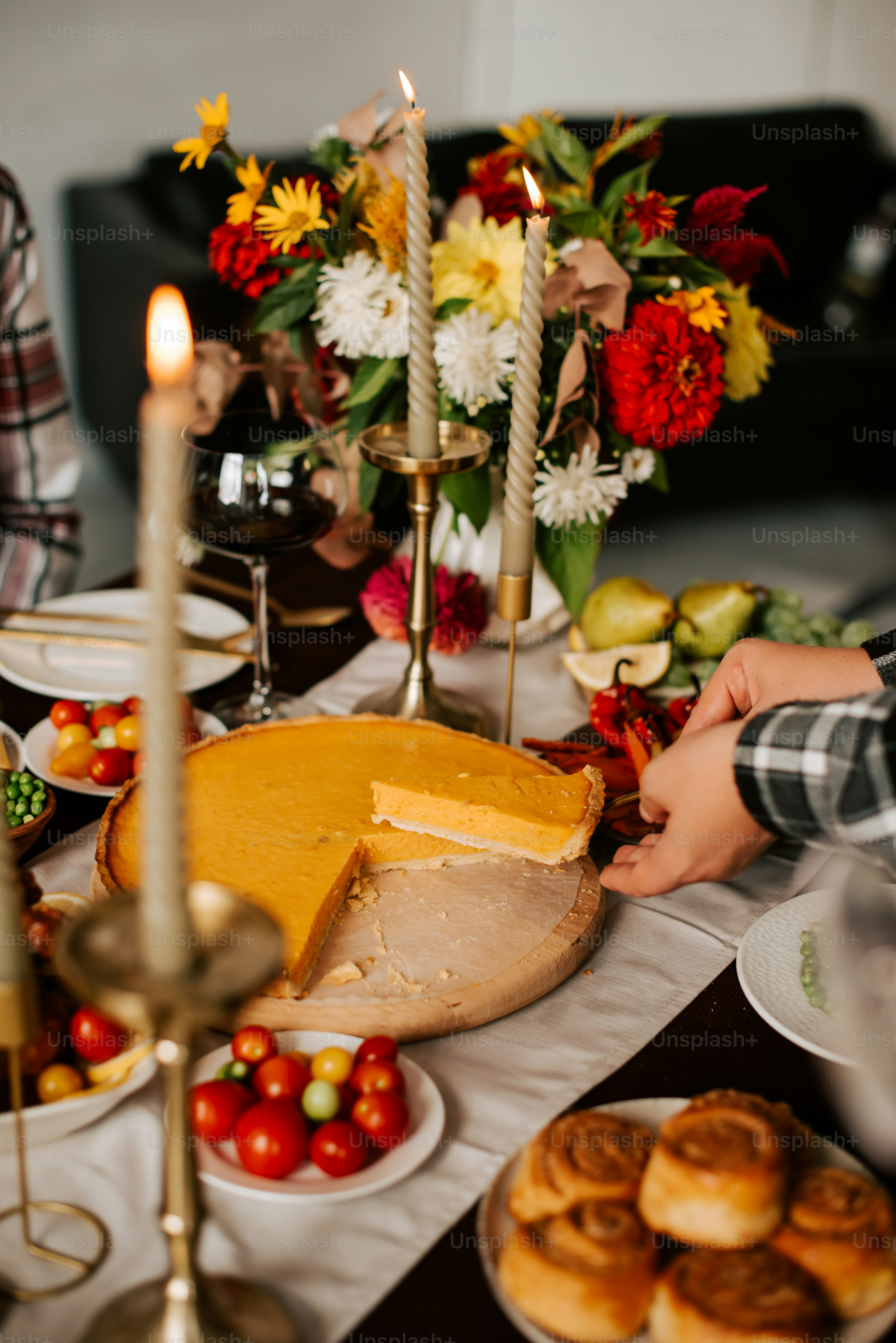 a table topped with lots of food and candles